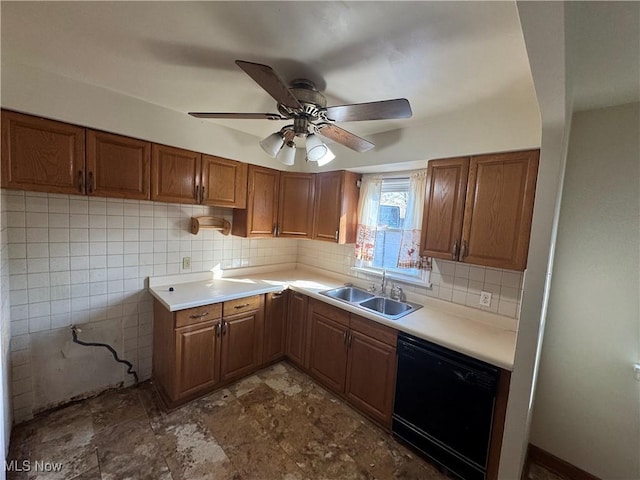 kitchen with tasteful backsplash, black dishwasher, brown cabinetry, and a sink