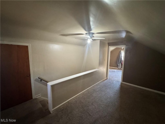 additional living space featuring carpet flooring, vaulted ceiling, and baseboards