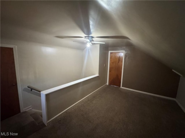 additional living space with carpet, vaulted ceiling, and a ceiling fan