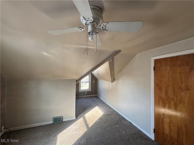 additional living space with baseboards, visible vents, a ceiling fan, vaulted ceiling, and carpet flooring