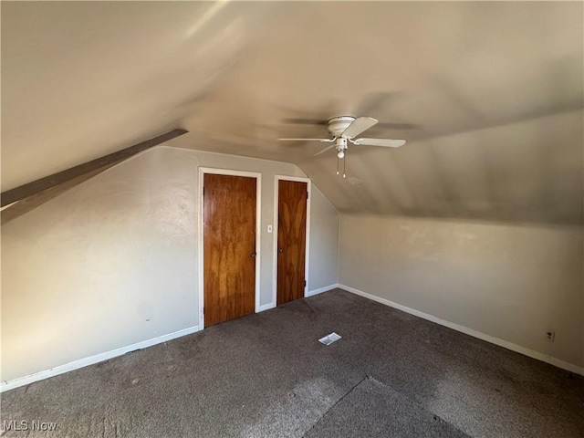 bonus room with lofted ceiling, ceiling fan, carpet flooring, and baseboards