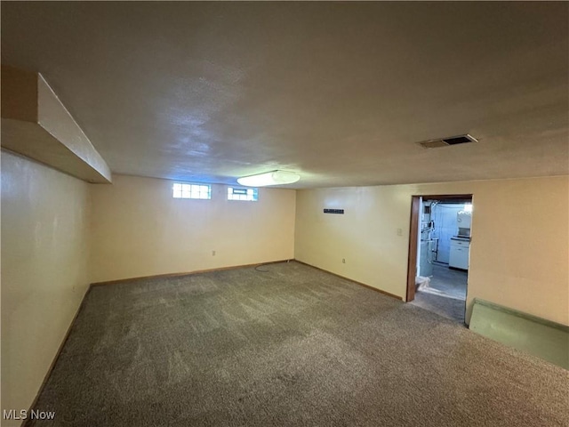 below grade area with carpet floors and visible vents