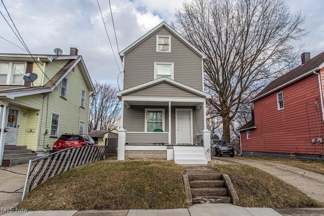 view of front of house featuring covered porch and fence