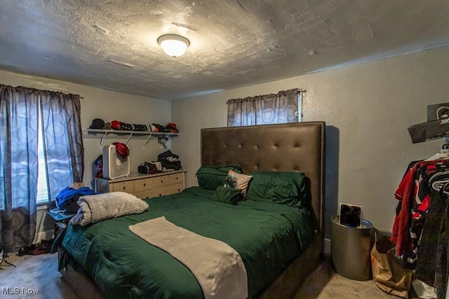 carpeted bedroom with a textured ceiling