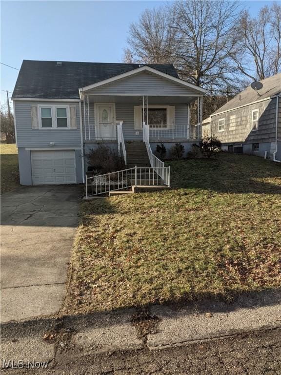 view of front of property with covered porch, a garage, stairs, driveway, and a front lawn