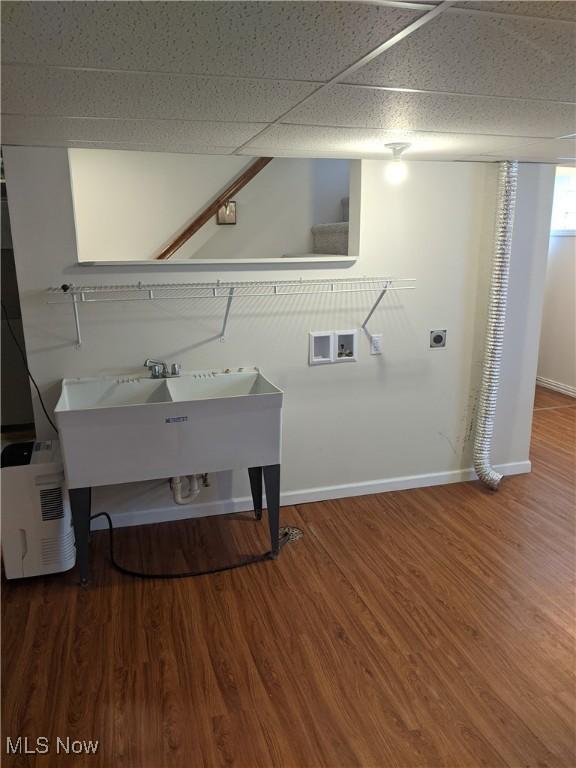 clothes washing area featuring laundry area, baseboards, wood finished floors, washer hookup, and electric dryer hookup