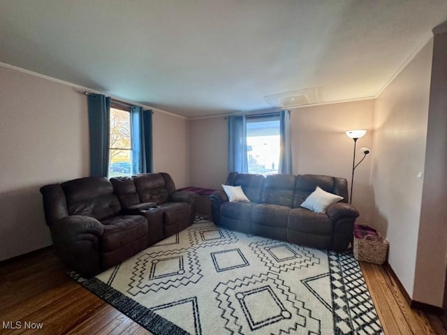 living room with ornamental molding and hardwood / wood-style floors