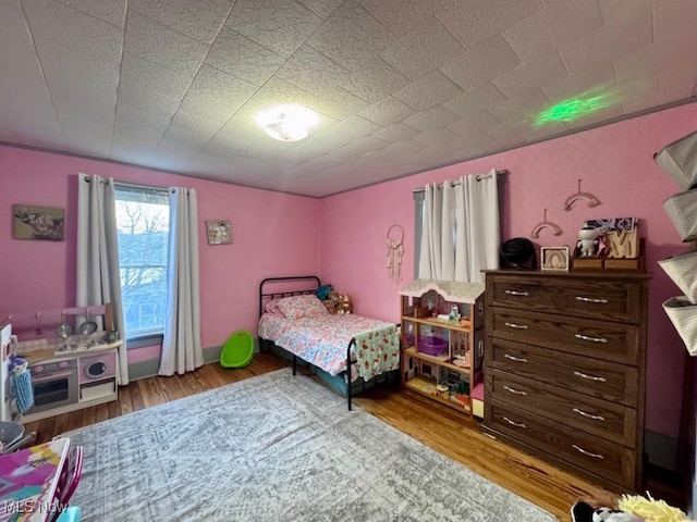 bedroom with wood finished floors