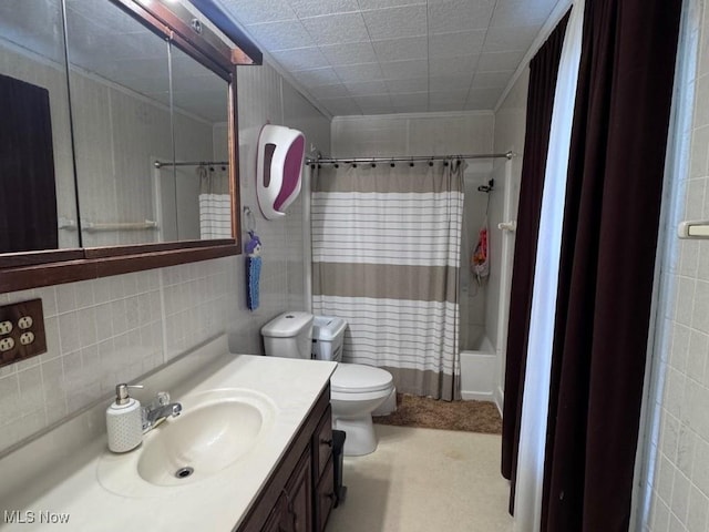 bathroom with toilet, tile walls, vanity, decorative backsplash, and shower / bath combo