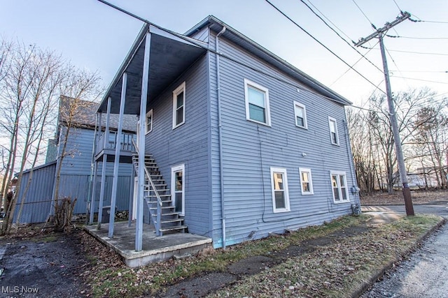 view of side of property featuring stairway