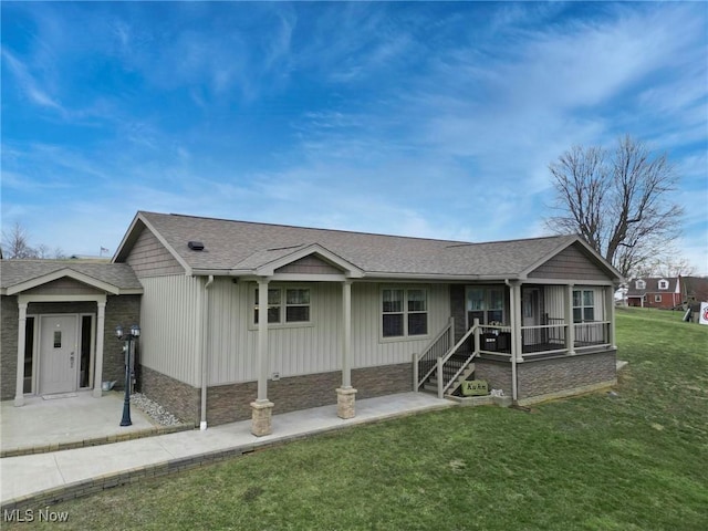 ranch-style home featuring roof with shingles and a front yard