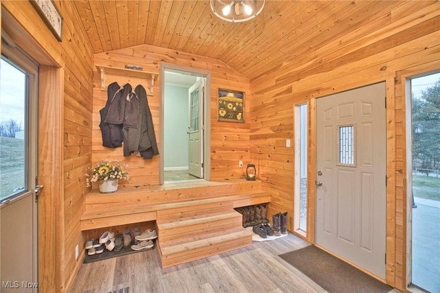 mudroom featuring wooden ceiling, vaulted ceiling, wooden walls, and wood finished floors