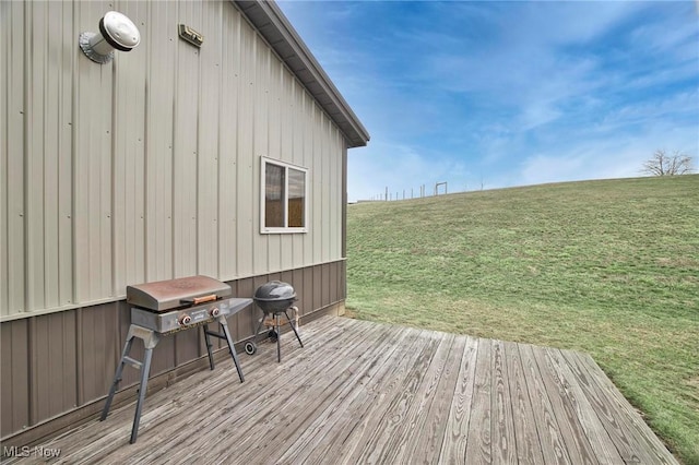 wooden deck featuring a lawn