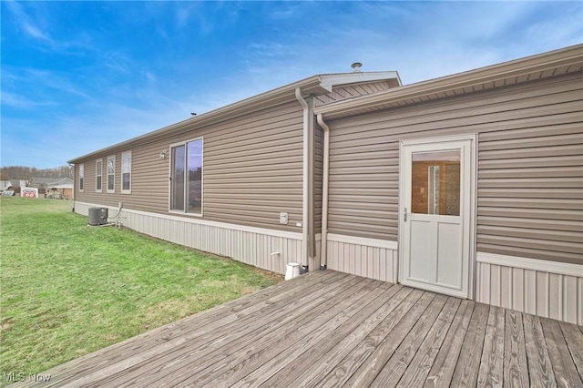 wooden deck with central AC and a yard