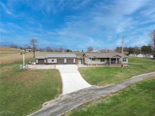 ranch-style house featuring driveway, an attached garage, a porch, and a front yard