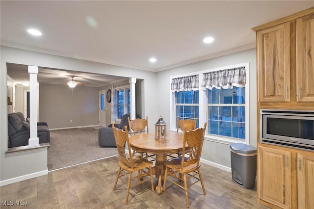 dining area with recessed lighting, crown molding, light wood finished floors, and baseboards