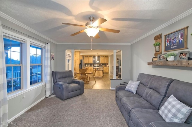 living room featuring light carpet, a textured ceiling, baseboards, and crown molding