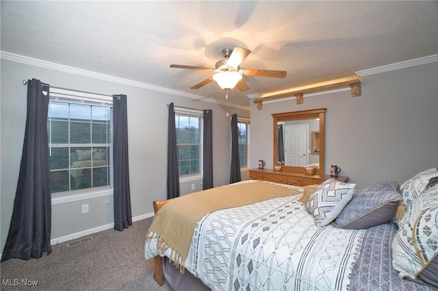 carpeted bedroom with baseboards, a ceiling fan, visible vents, and crown molding