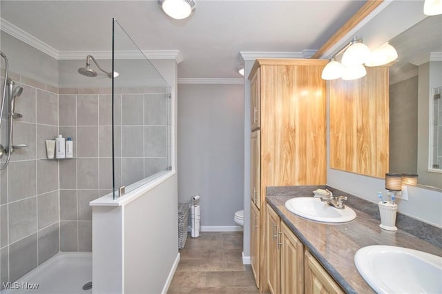 full bath featuring a walk in shower, toilet, a sink, ornamental molding, and double vanity