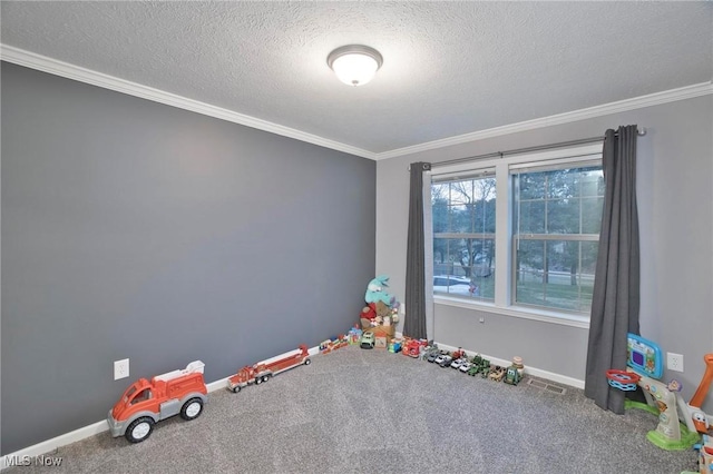 recreation room with carpet floors, a textured ceiling, and baseboards