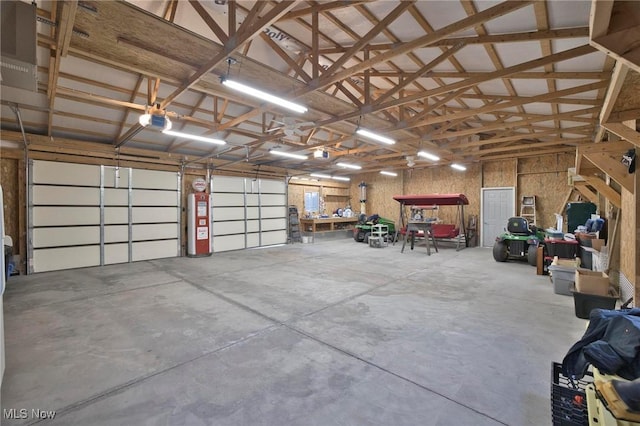 garage with a garage door opener and water heater