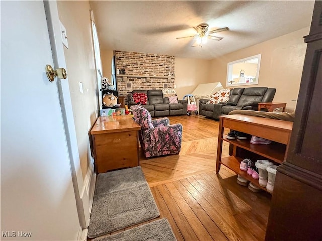 living area featuring ceiling fan and hardwood / wood-style floors