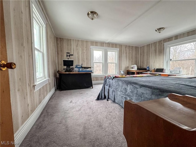 bedroom with baseboards, multiple windows, and carpet flooring