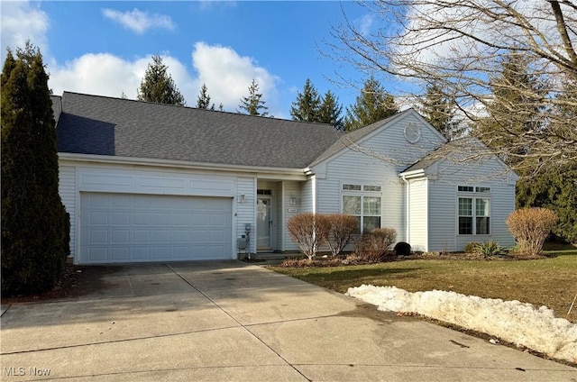 view of front facade featuring a garage, concrete driveway, and roof with shingles