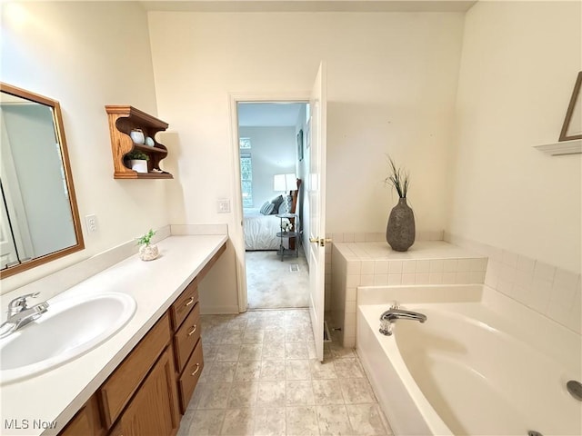 ensuite bathroom featuring ensuite bath, a bath, and vanity