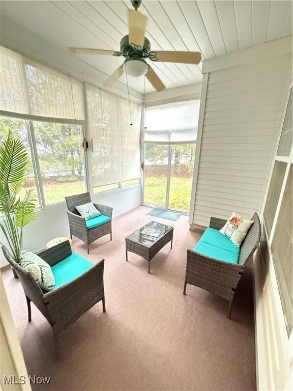 sunroom featuring a ceiling fan