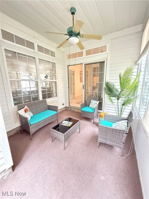 sunroom / solarium with wood ceiling and ceiling fan