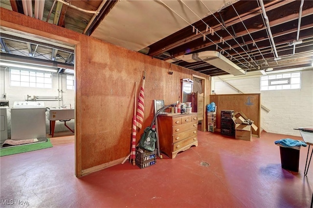 below grade area featuring a sink and washing machine and clothes dryer