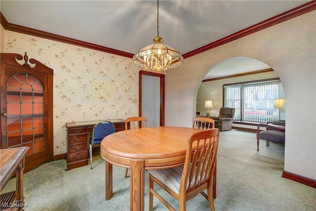 dining area with wallpapered walls, carpet, arched walkways, and baseboards