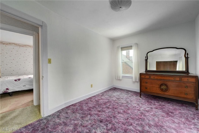 bedroom with carpet floors and baseboards