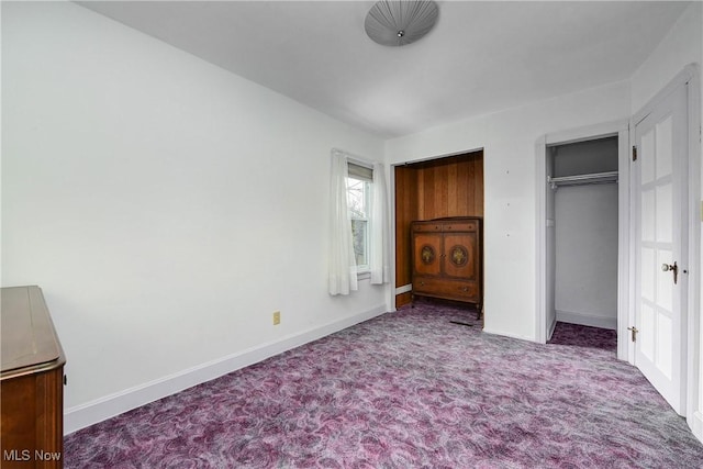 unfurnished bedroom featuring carpet and baseboards