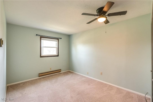 carpeted spare room with baseboards, a baseboard heating unit, and a ceiling fan