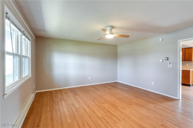 unfurnished room with a baseboard heating unit, ceiling fan, light wood-type flooring, and baseboards