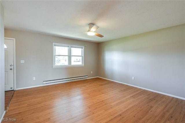 unfurnished room featuring a baseboard heating unit, baseboards, light wood finished floors, and a ceiling fan