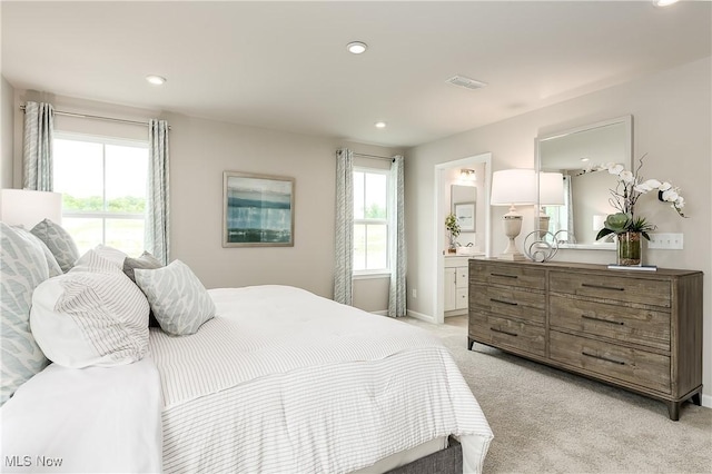 bedroom with recessed lighting, light carpet, connected bathroom, and visible vents