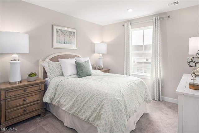 bedroom featuring light carpet, baseboards, and visible vents