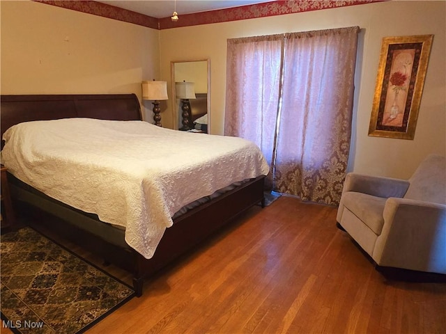 bedroom with wood finished floors