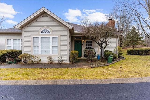 142 Wilcox Rd, Austintown, OH 44515 - view of front of house featuring a chimney, a front lawn, and a shingled roof