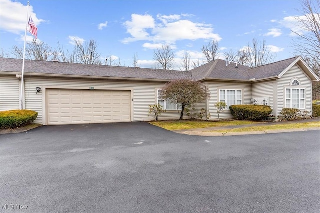 ranch-style home with driveway and an attached garage