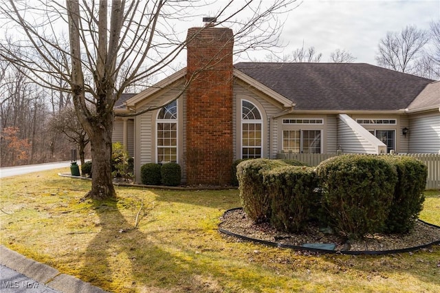 142 Wilcox Rd, Austintown, OH 44515 - view of side of property with a chimney, a lawn, and roof with shingles