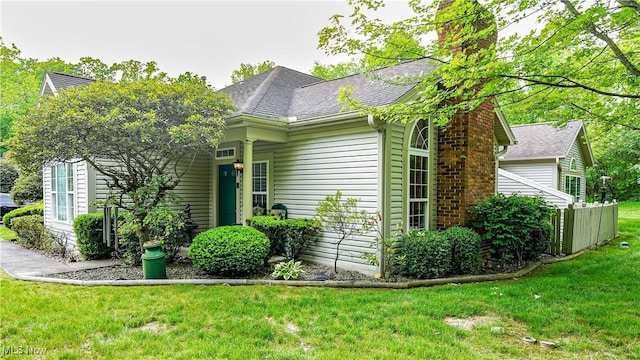 142 Wilcox Rd, Austintown, OH 44515 - view of front facade featuring a chimney, a front lawn, and roof with shingles