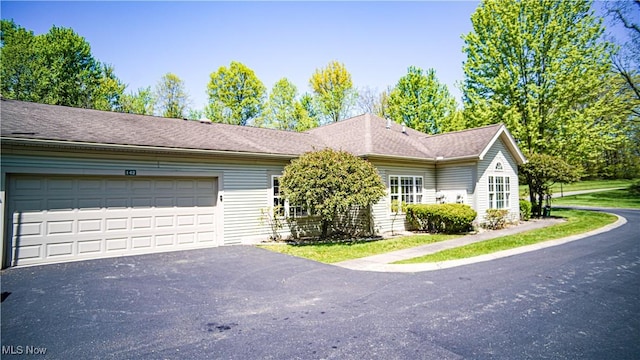 142 Wilcox Rd, Austintown, OH 44515 - view of front of property with asphalt driveway and a garage
