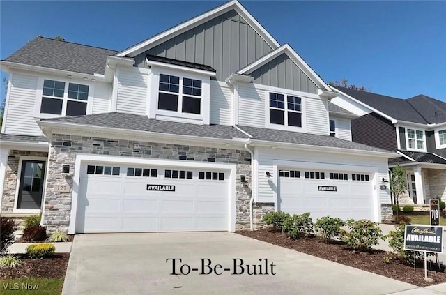 view of front of property featuring concrete driveway, stone siding, roof with shingles, an attached garage, and board and batten siding