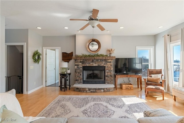 living area with recessed lighting, baseboards, and wood finished floors