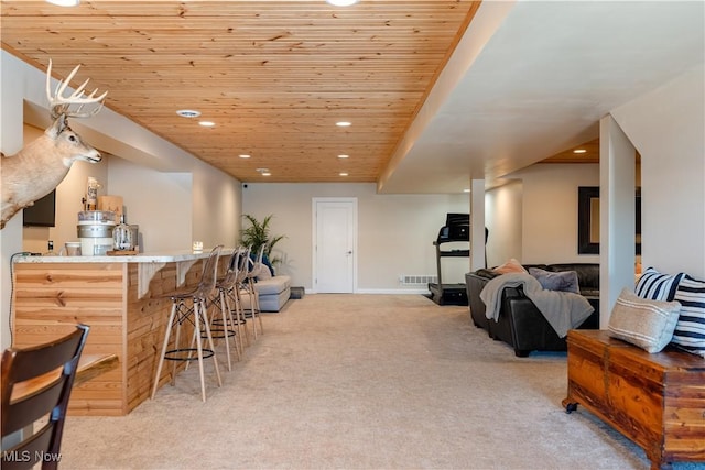 interior space with a dry bar, visible vents, wooden ceiling, carpet floors, and recessed lighting