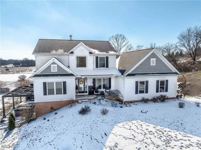 snow covered house with an attached carport